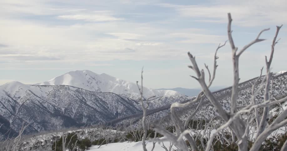 Snow on mountains in wilderness on cloudy day