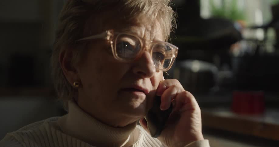A woman is inside a building talking on her cellphone