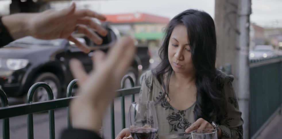 A woman talks and eats with a friend