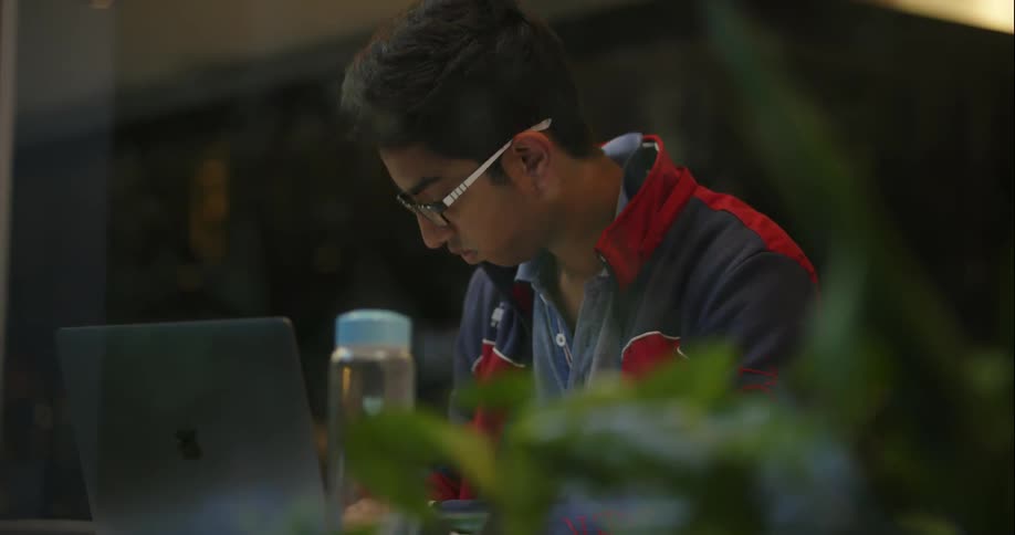 A man works at a laptop