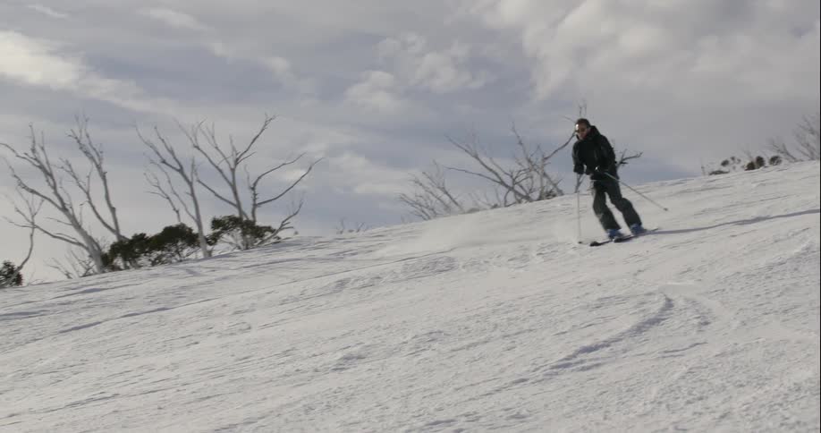 Person skis down a large hill