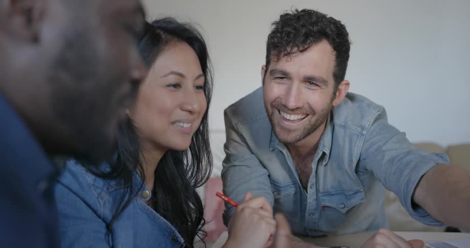People sit around a table talking
