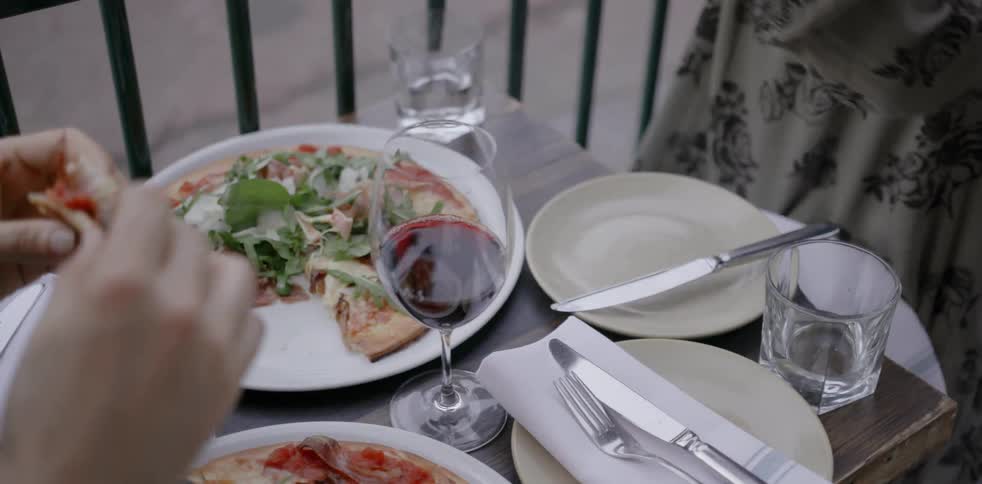 People dine at a small restaurant table