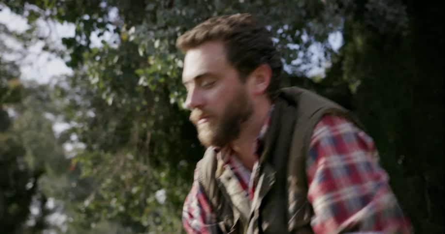 A man cuts wood with an axe