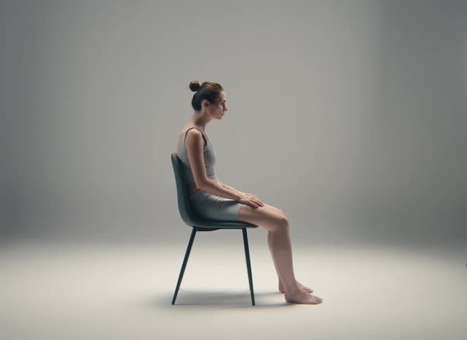 Woman seated in profile on a chair