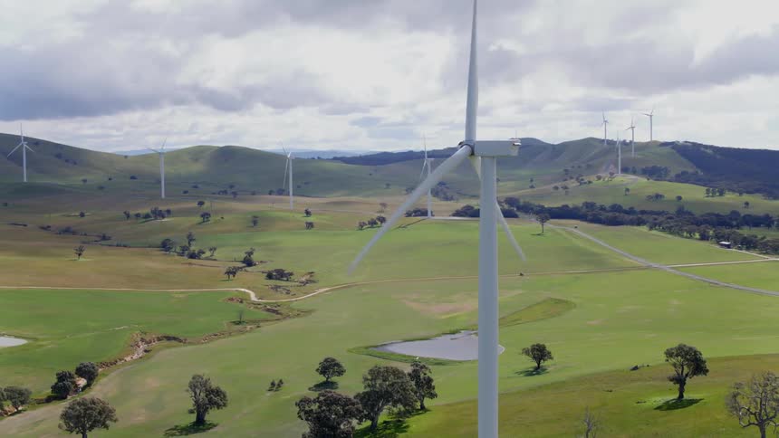 Wind turbines rotate on a cloudy day