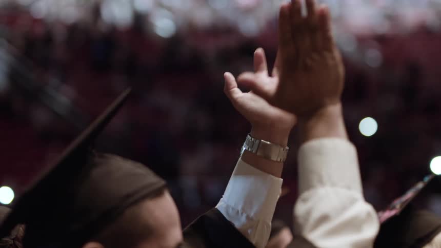 People clap at a graduation