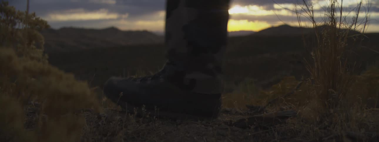 The ground was deserted one morning and a person was walking by wearing black boots