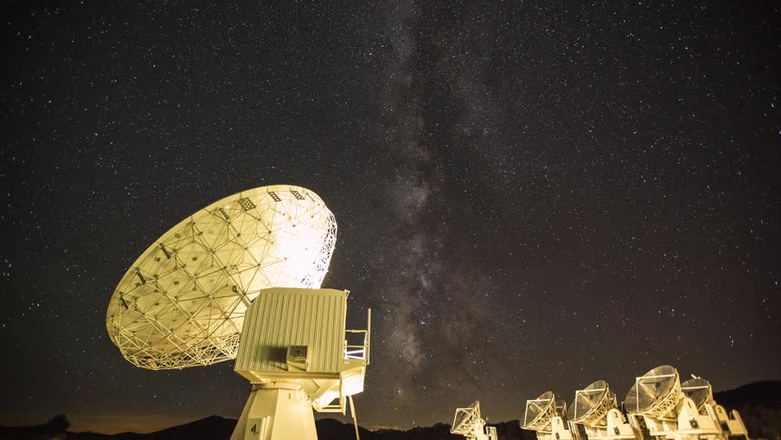 A view of radio antennas looking at the milky way