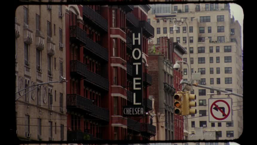 Hotel chelsea with heavy traffic and people on the streets outdoors during day time