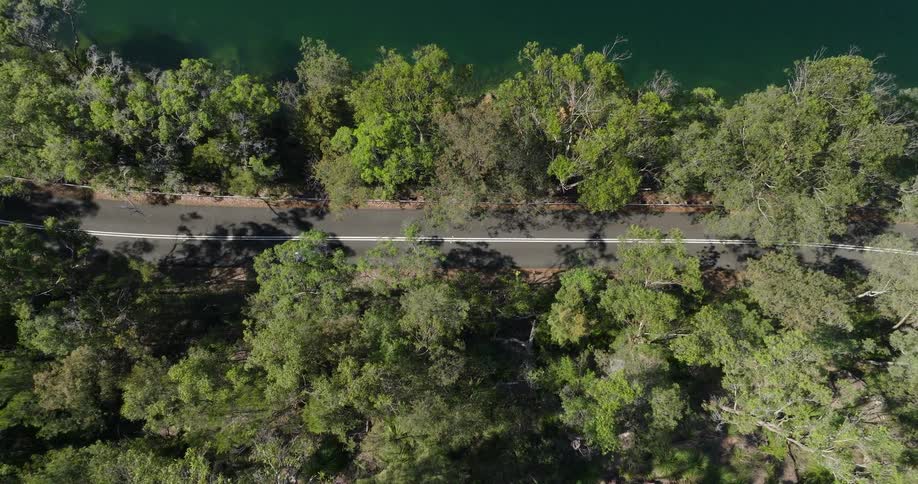 An aerial view of a car driving down a road