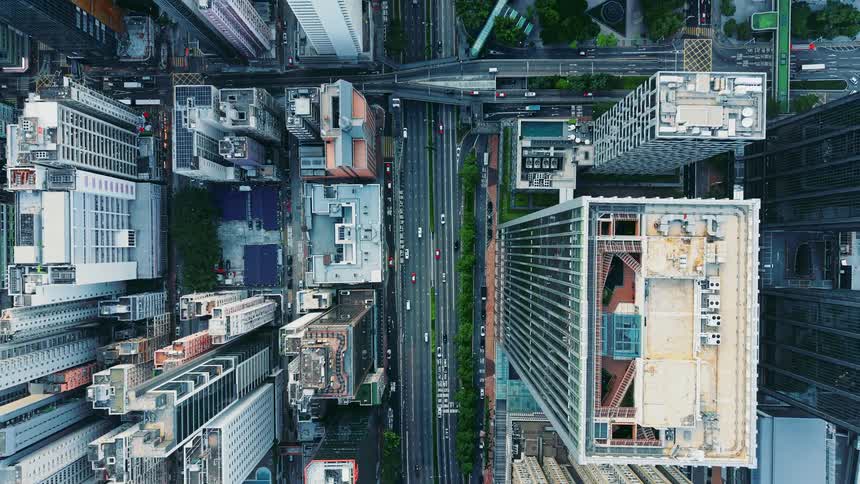 Skyscrapers and urban roads seen from above forming a dense layout of buildings and avenues