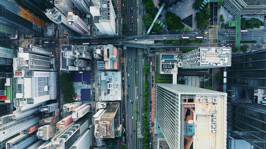 Skyscrapers and urban roads seen from above forming a dense layout of buildings and avenues