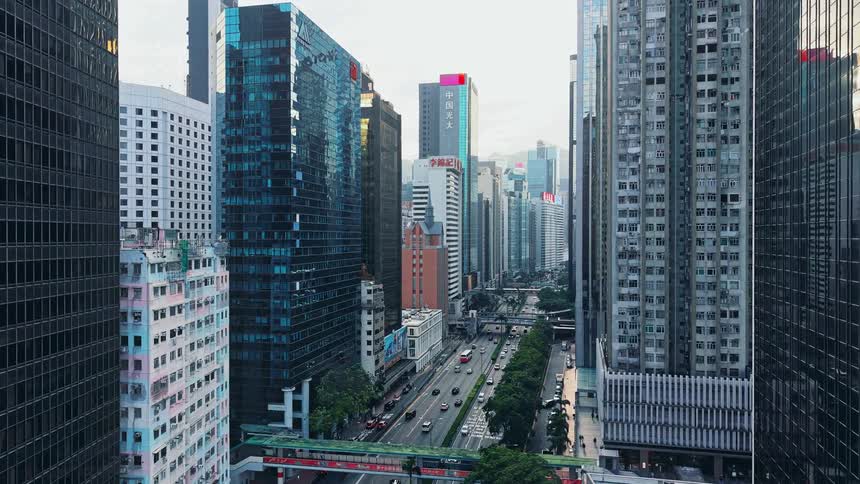 Aerial footage of Downtown Financial District lined with tall business buildings with cars moving along the lanes