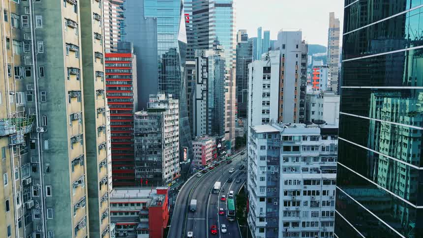Camera travels through busy business area with tall high rises buildings