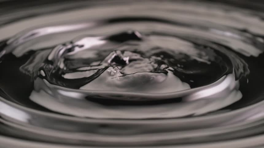 Ripples on the surface of a dark liquid intensify into a chaotic splash