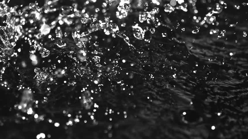 A view of water drops falling onto water