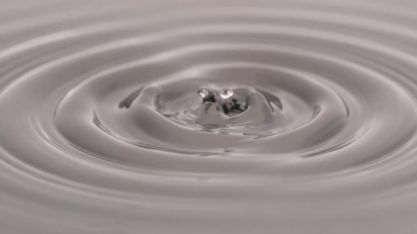 Gray liquid forming protrusions and raised droplets after impact