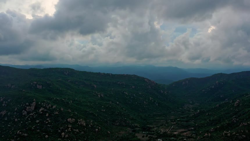 Homes are spread out at the bottom of the mountains