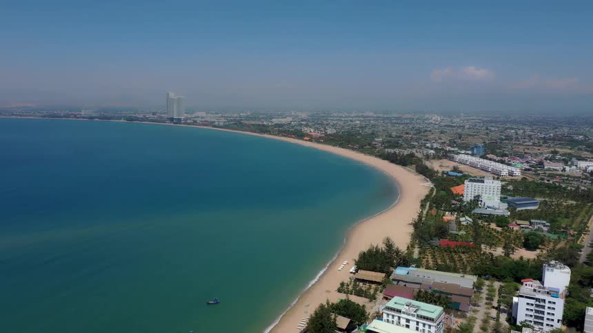 Beach next to a metropolitan area outdoors during day time
