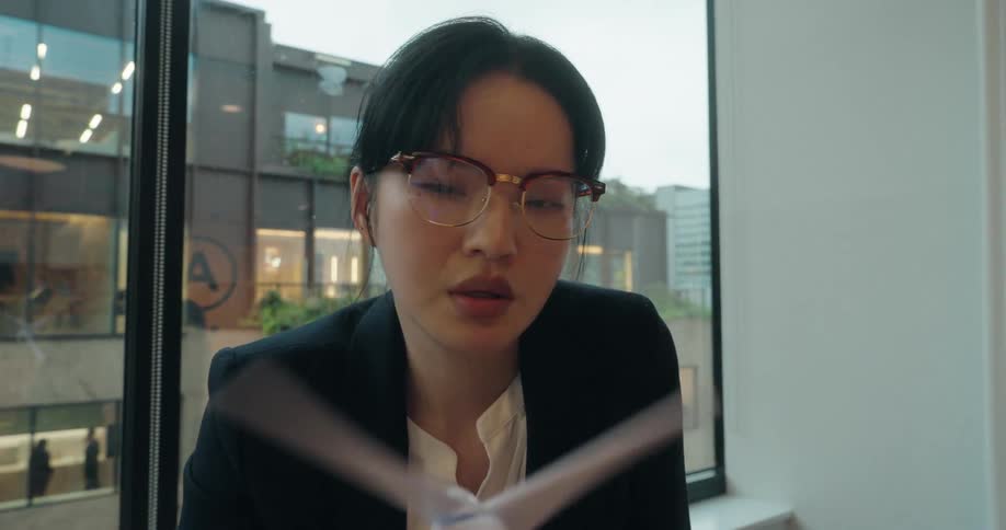 The woman in the office examines a model windmill