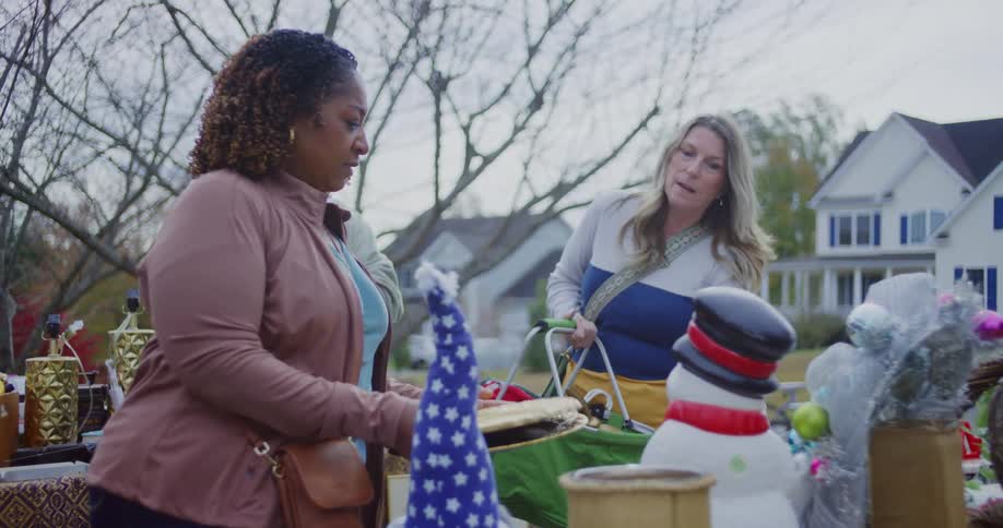 A group of people shopping at a yard sale