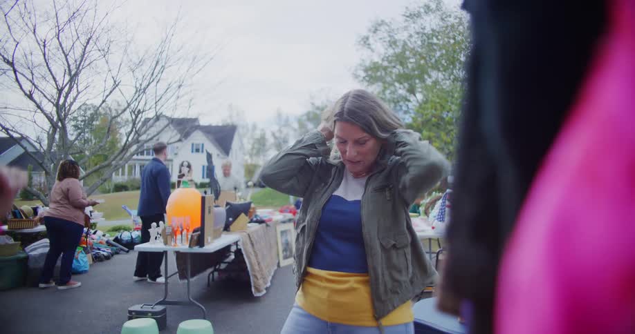 A group of people shopping at a yard sale