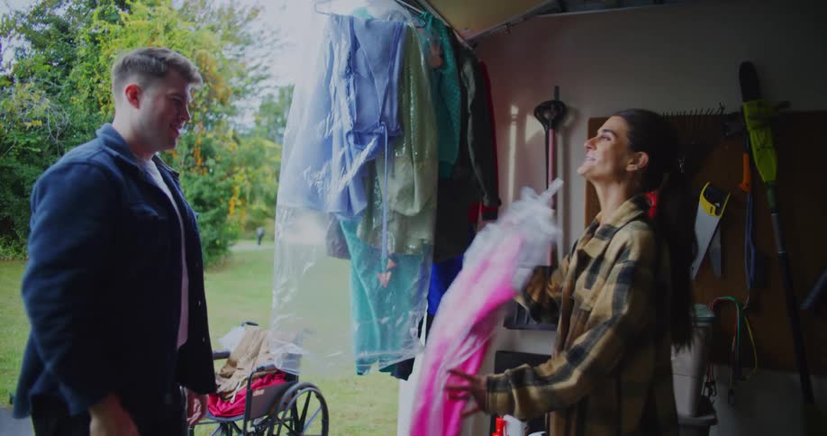 Two people shopping for clothes at a yard sale