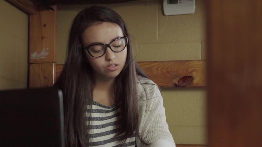 Teenager reads a notebook