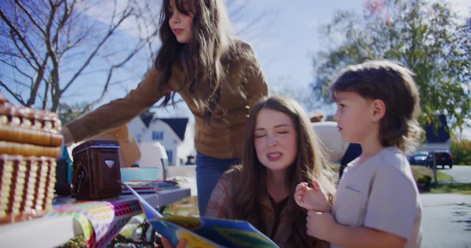 A group of people shopping at a yard sale