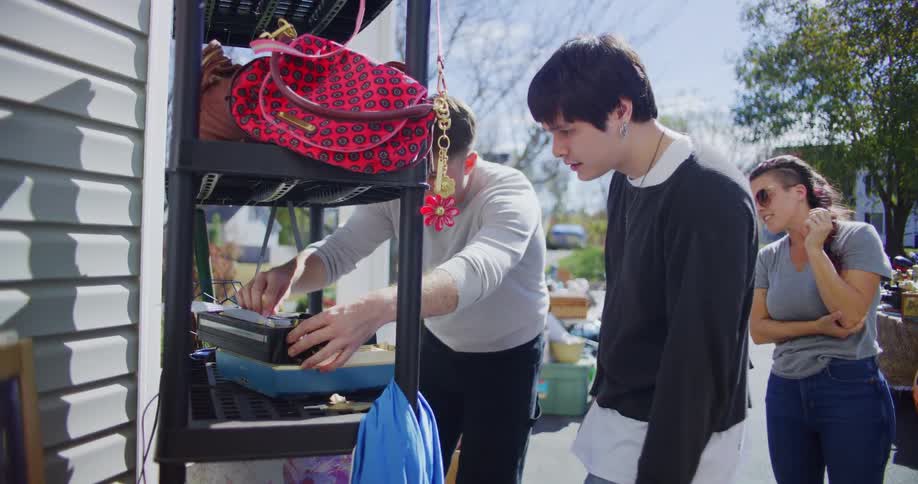 A group of people shopping at a yard sale