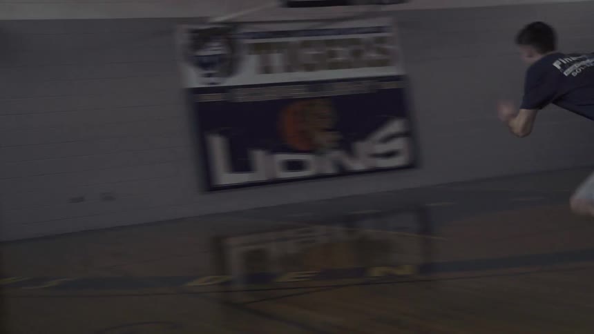 A man sprints back and forth on a basketball court