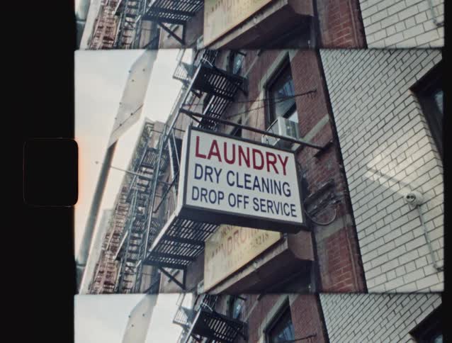 Laundry sign shows dry cleaning and dropoff services on the front of a building
