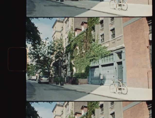 Residential street with vinecovered buildings a parked car and a bicycle on the sidewalk