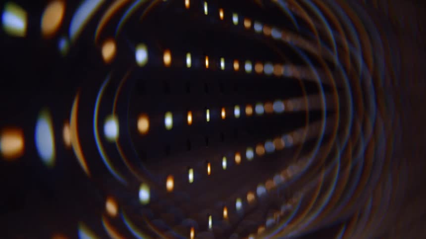 Multi colored arches connect some of the colorful dots forming rows against a dark background