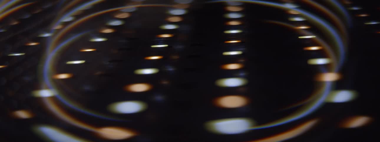 A large array of subtly colored lights are set against a dark background
