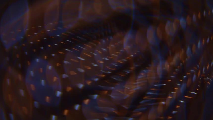 Numerous small lights are aligned in rows against a dark backdrop