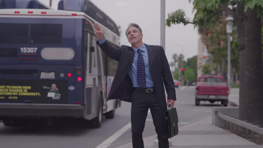 A person hailing a bus outdoors