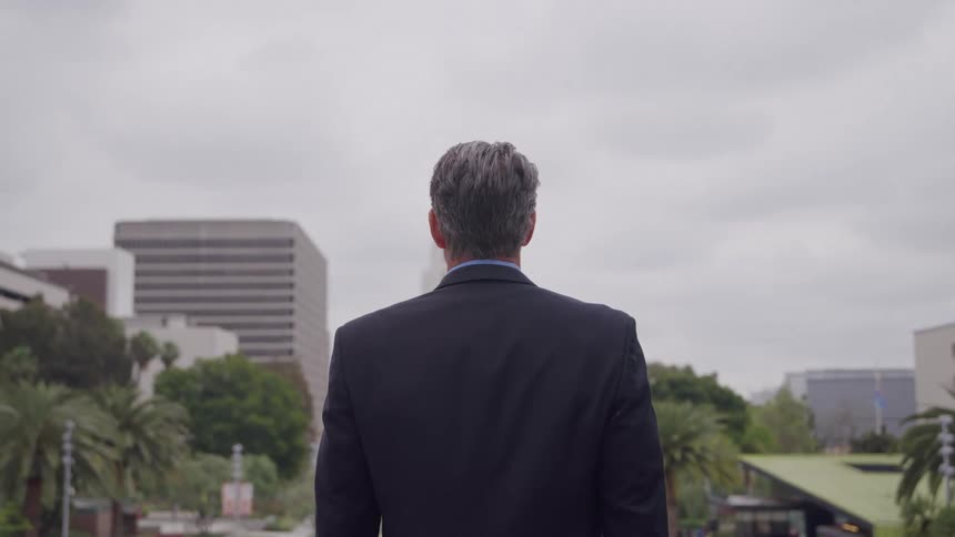 A man wearing a suit standing outdoors