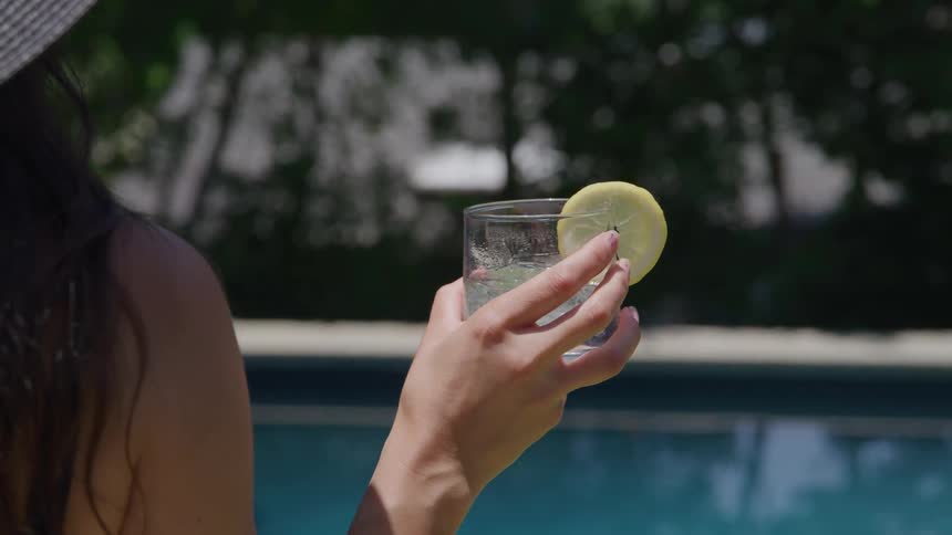 A woman holding a cocktail in her hands