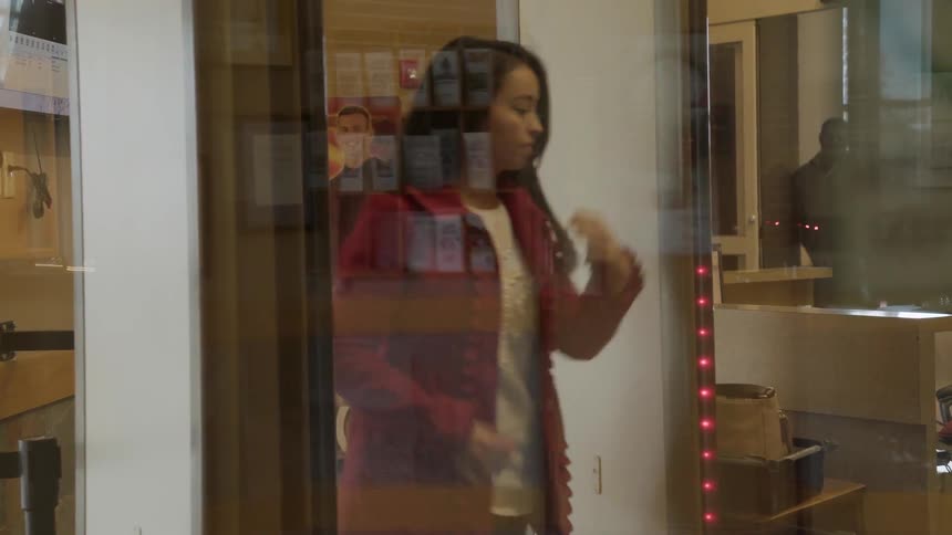 A woman walks through a metal detector