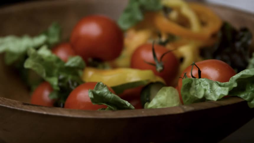 Salad is landing in the bowl