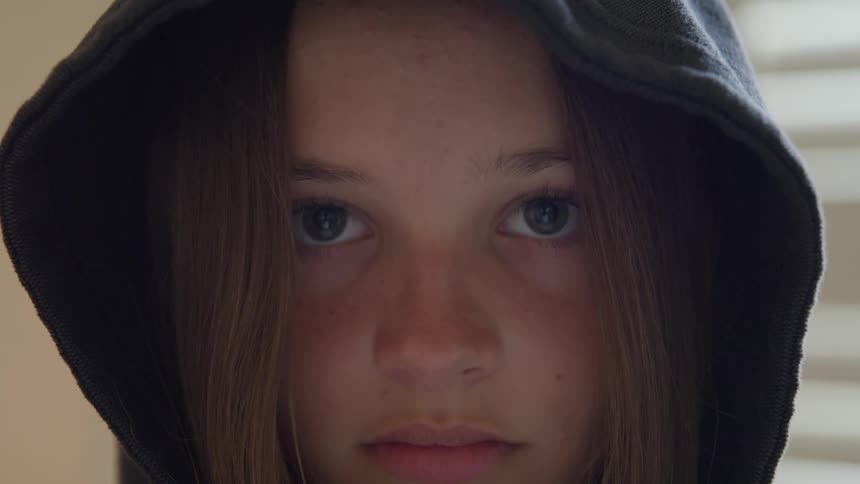 The girl is wearing a black hood
