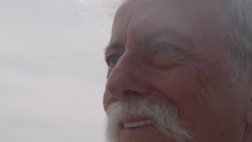 Closeup of an older mans face looking into the distance