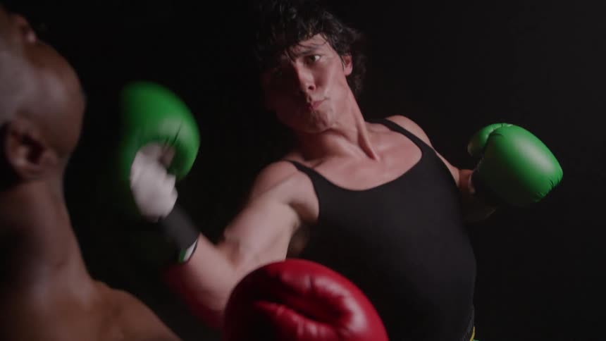 The man gives an uppercut during a boxing match