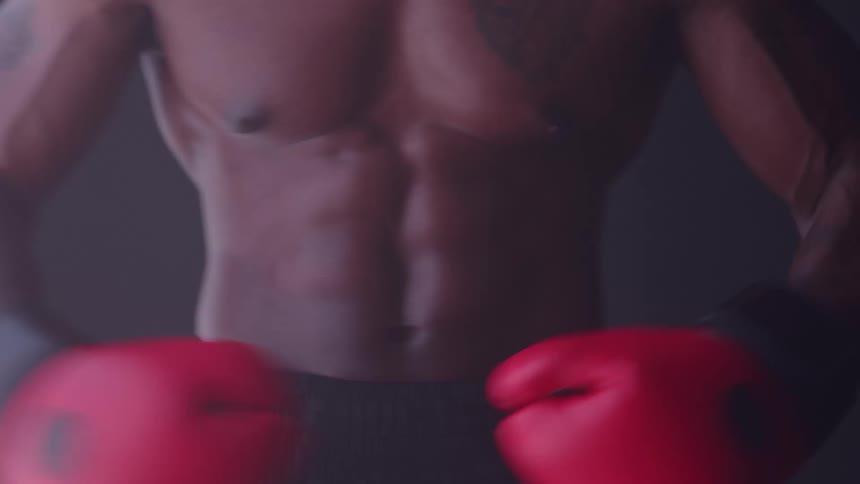 The boxer punches his gloves together