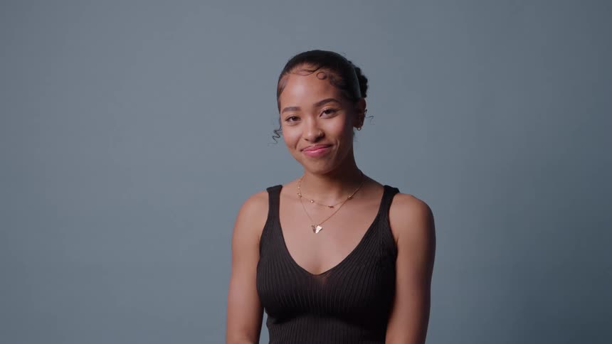 Woman posing in front of a blue background