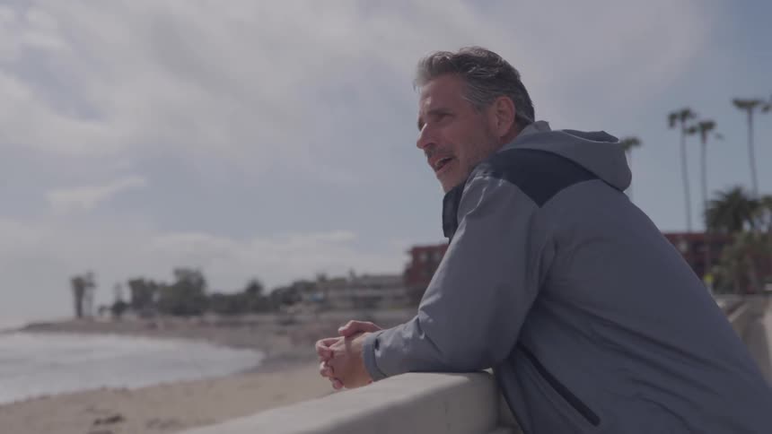 Portrait of a middle aged man standing outdoors in a city during daytime