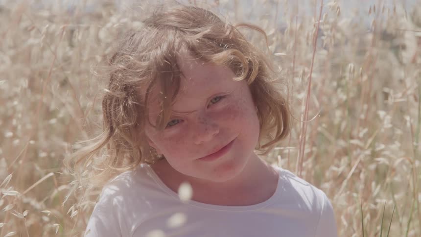 A portrait of a child sitting outdoors
