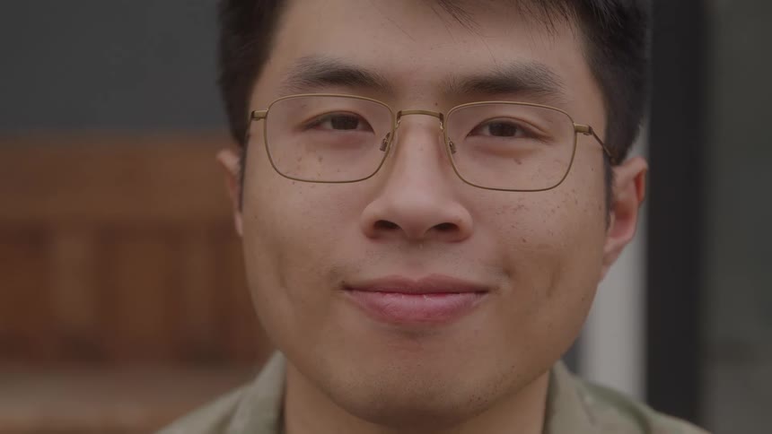 A portrait of a man with glasses